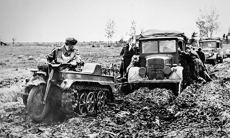 Kettenkrad pulling trucks through mud in the Eastern Front