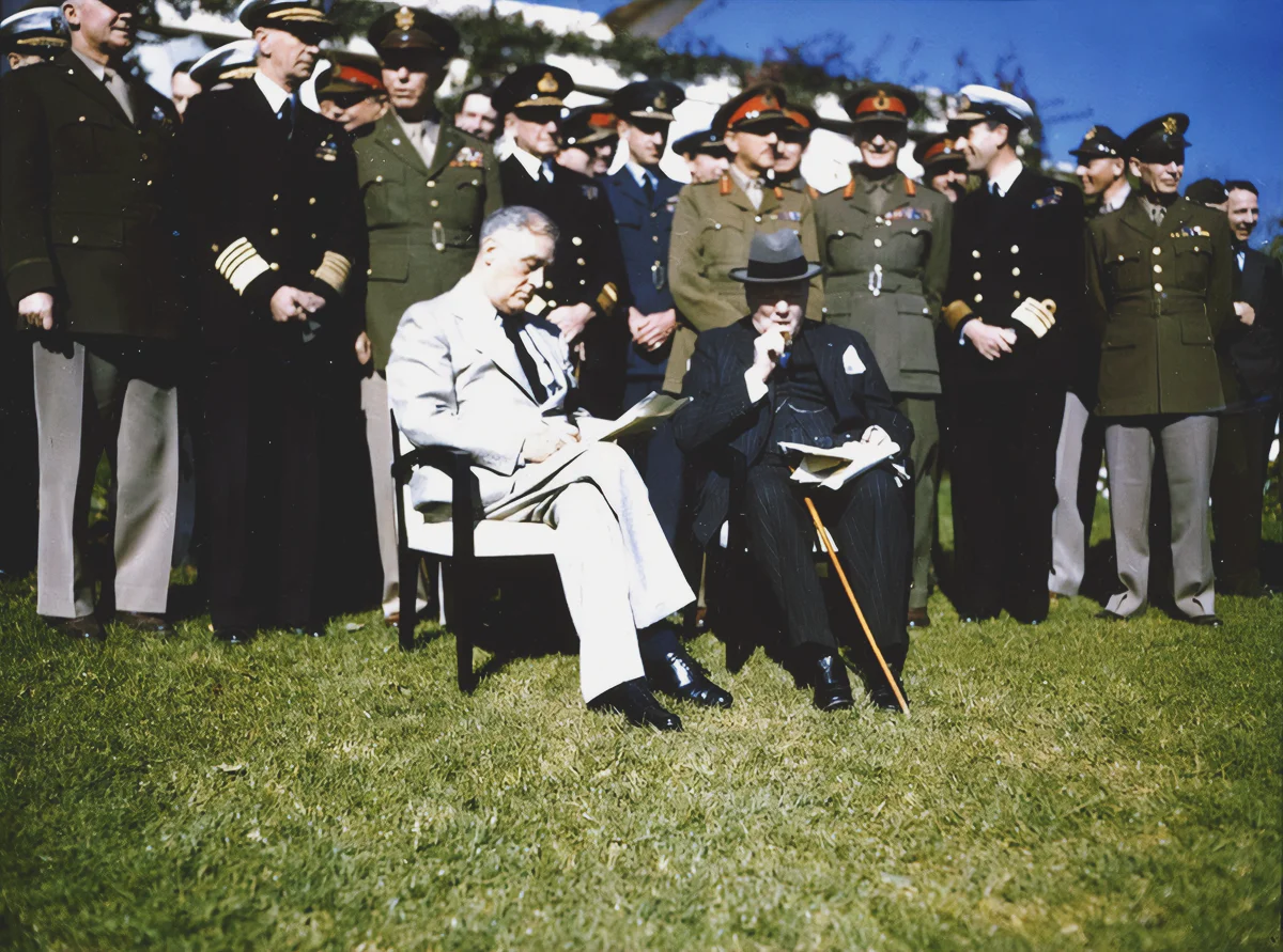 American President Franklin Delano Roosevelt (1882 - 1945) (seated left) and British Prime Minister Winston Churchill (1874 - 1965) (seated right) review documents at the Casablanca Conference where they planned Allied strategy for the European campaign in World War II, Casablanca, Morrocco, January 17, 1943. Among those behind them are, from left, Chief of the US Army Forces Lieutenant General Henry 'Hap' Arnold (1885 - 1950), Commander-in-Chief of the US Navy Admiral Ernest J. King (1878 - 1956), US Chief of Staff General George C. Marshall (1880 - 1959), Chief of British Naval Staff Admiral Sir Dudley Pound (1877 -1943), Chief of the Imperial General Staff General Sir Alan Brooke (1883 - 1963), and Air Chief Marshall Sir Charles Portal (1893 - 1971)